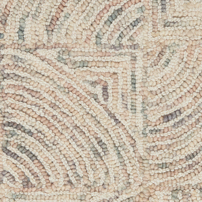 Boucle woven rug close-up with circular spiral motifs in cream, blush pink, light gray and sage.