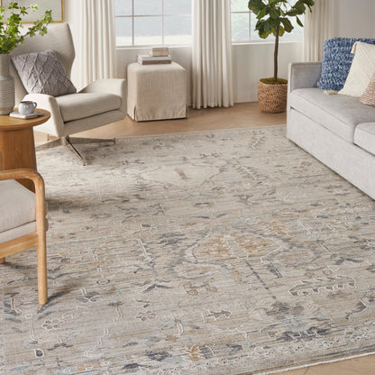 Neutral-toned oriental area rug with beige, gray and pale blue accents in a bright living room.