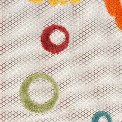 Beige woven rug with fuzzy multicolor circular ring motifs in red, green, teal and orange.