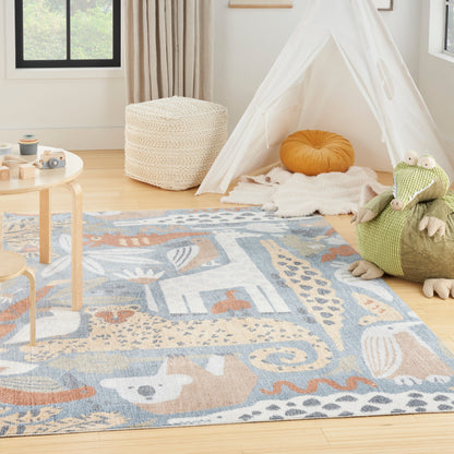 Kids' rug with an animal design in a playroom, alongside a white teepee tent with sheer panels, an orange cushion, a woven pouf, and a green plush crocodile.