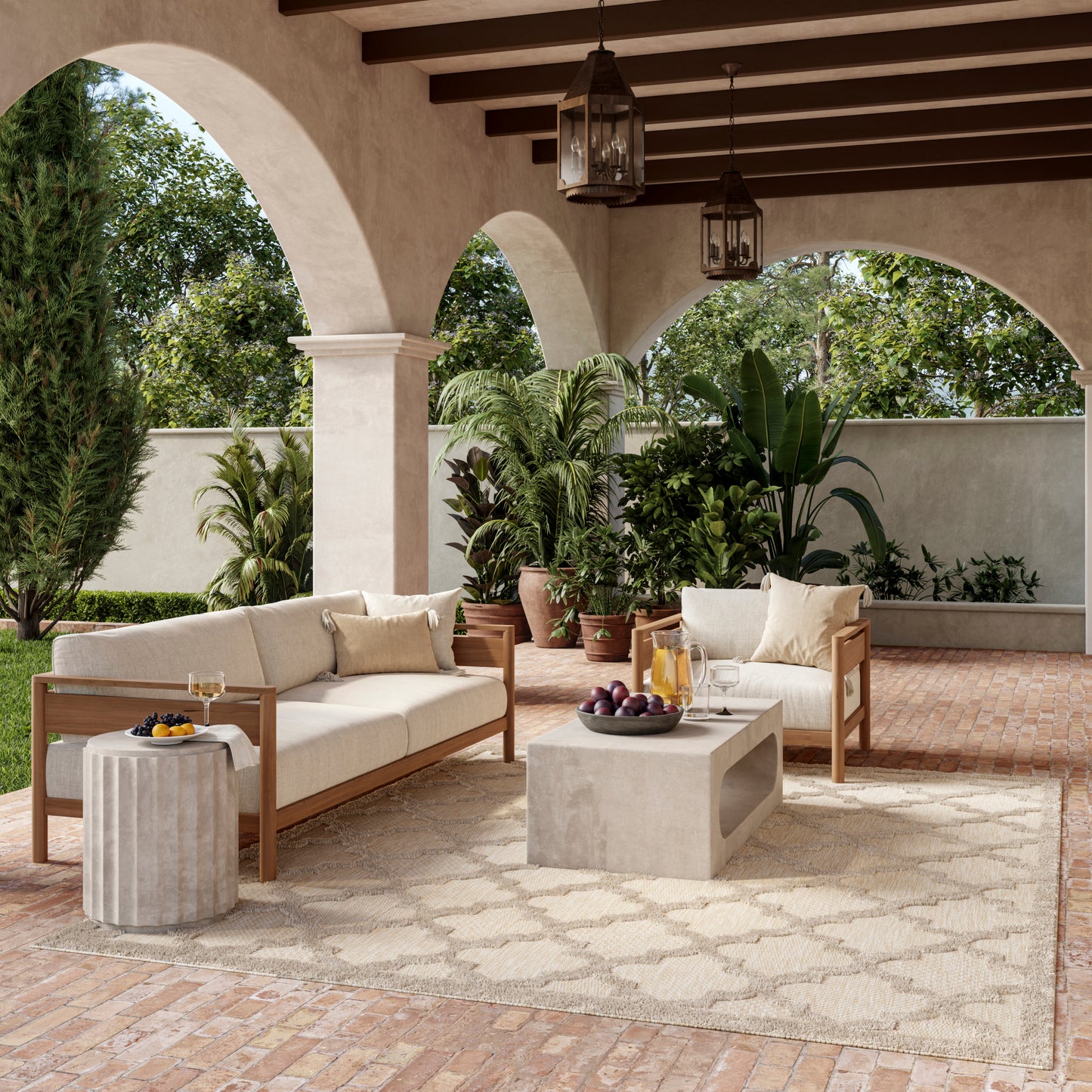 Outdoor lounge area featuring a modern 9' x 12' rug under cream cushions on a wooden-frame sofa and chairs, with a concrete coffee table, beige tones, and potted plants.