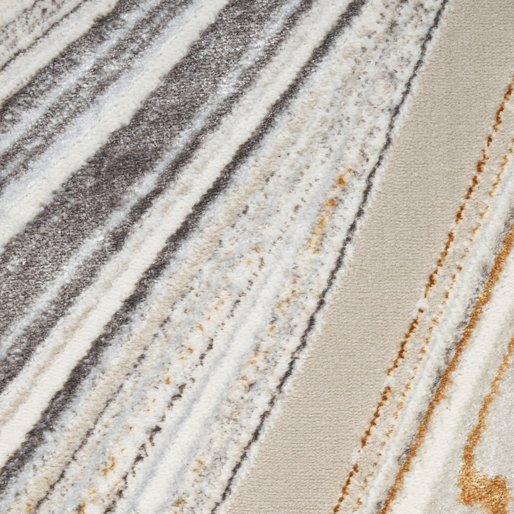Diagonal striped plush area rug in gray, ivory, beige and gold tones with a soft textured pile.
