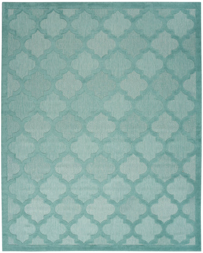 Rectangular teal area rug with repeating quattrofoil trellis pattern and subtle gradient.
