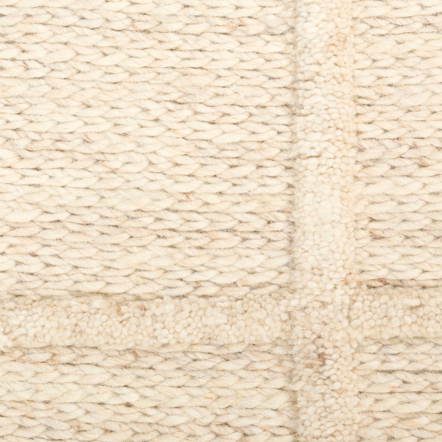 Cream chunky knit rug with square patchwork panels in boucle wool.