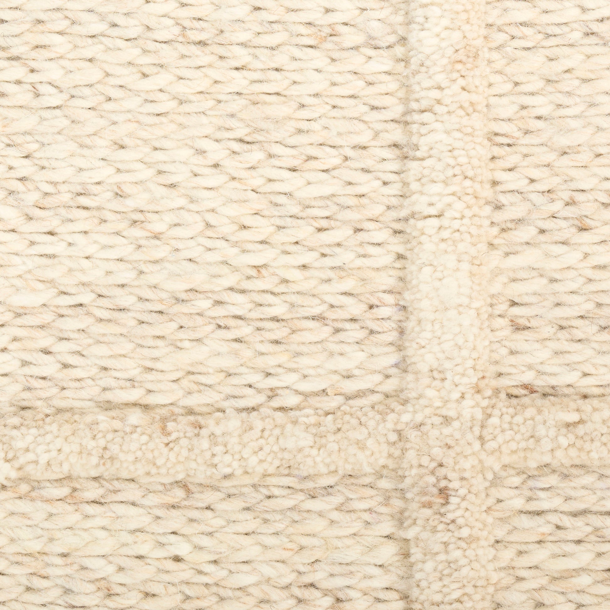 Cream chunky knit rug with square patchwork panels in boucle wool.