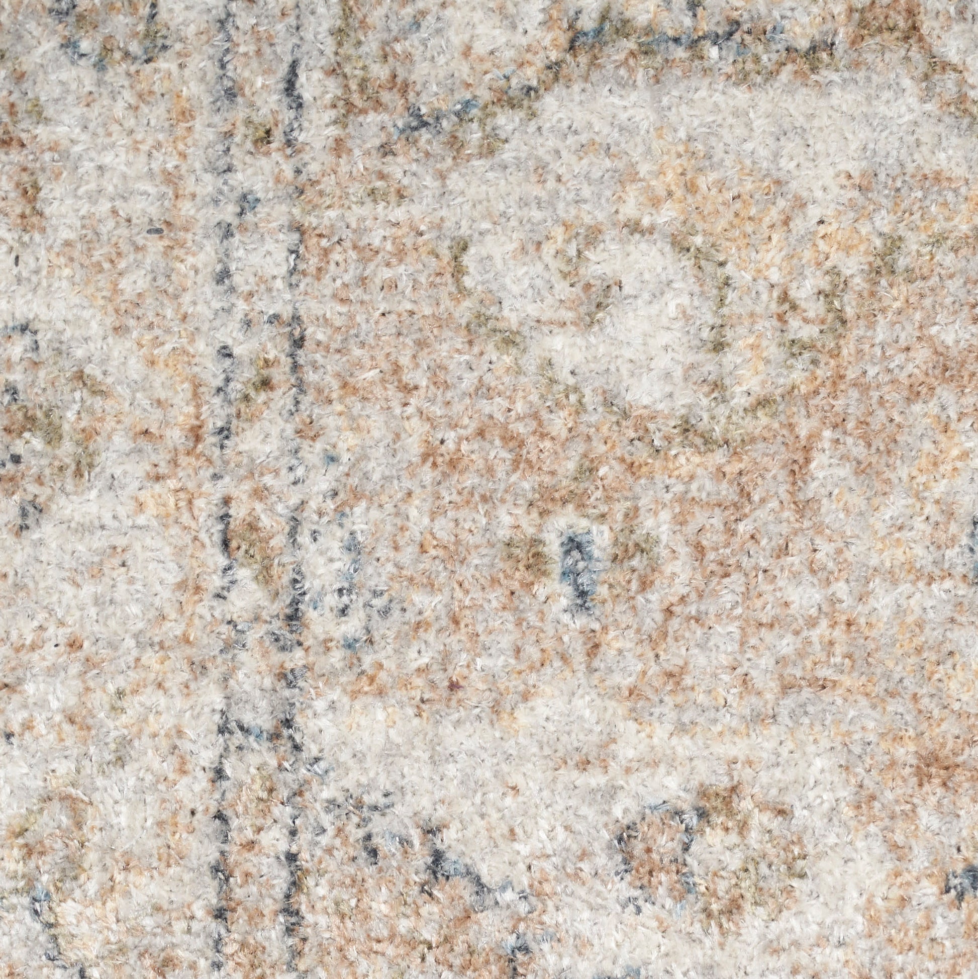 Close-up of a neutral-toned shag rug with cream, beige, tan and pale blue accents; soft textile texture.