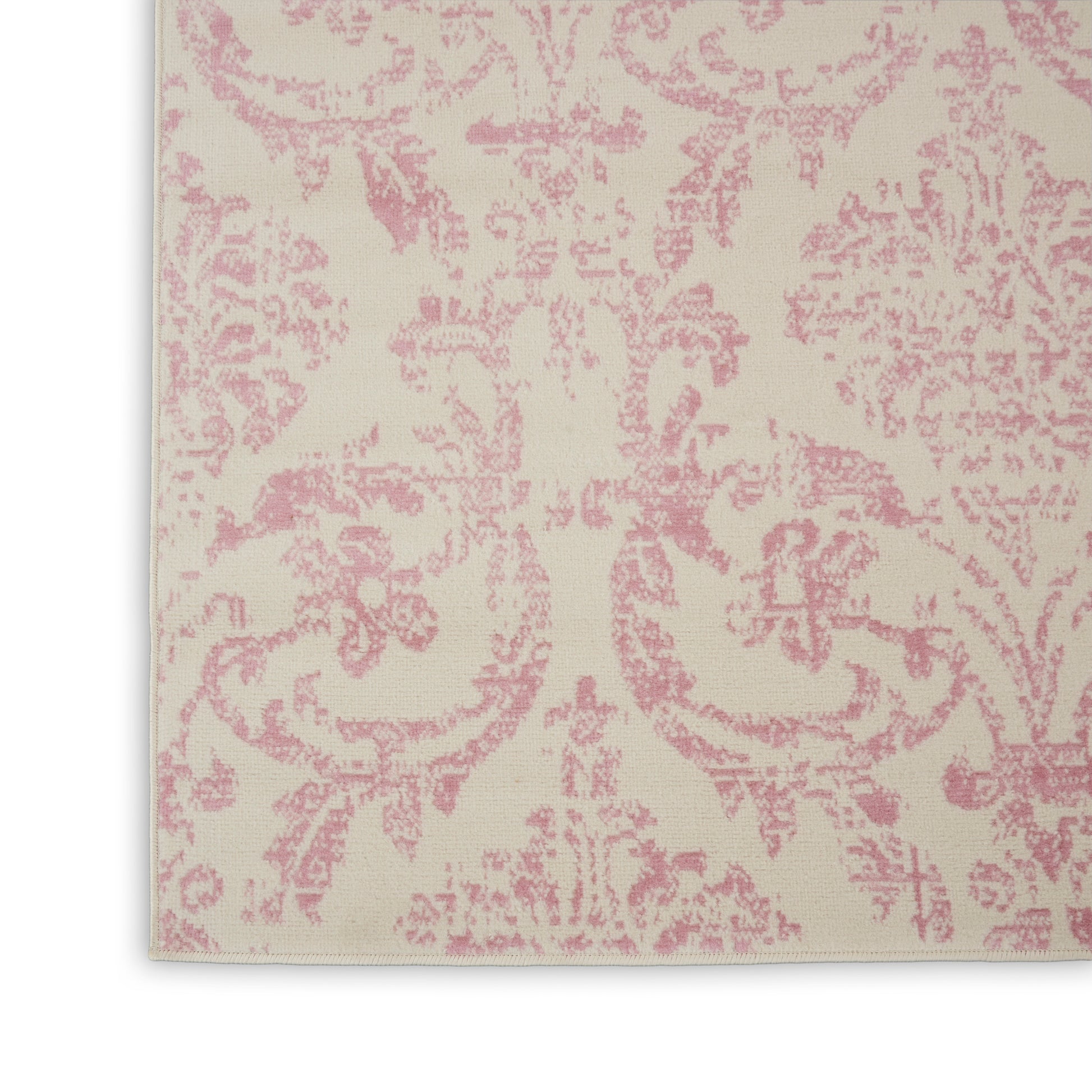 Cream fabric with pink damask floral pattern, decorative textile swatch.