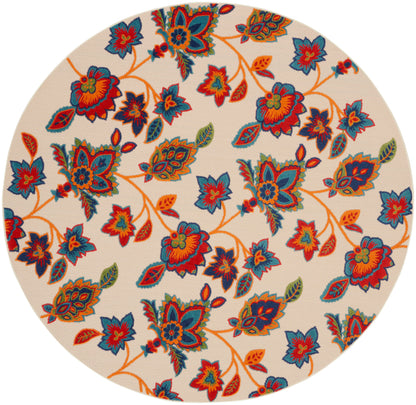 Round beige area rug with vivid blue, orange and red floral pattern and leafy vines.