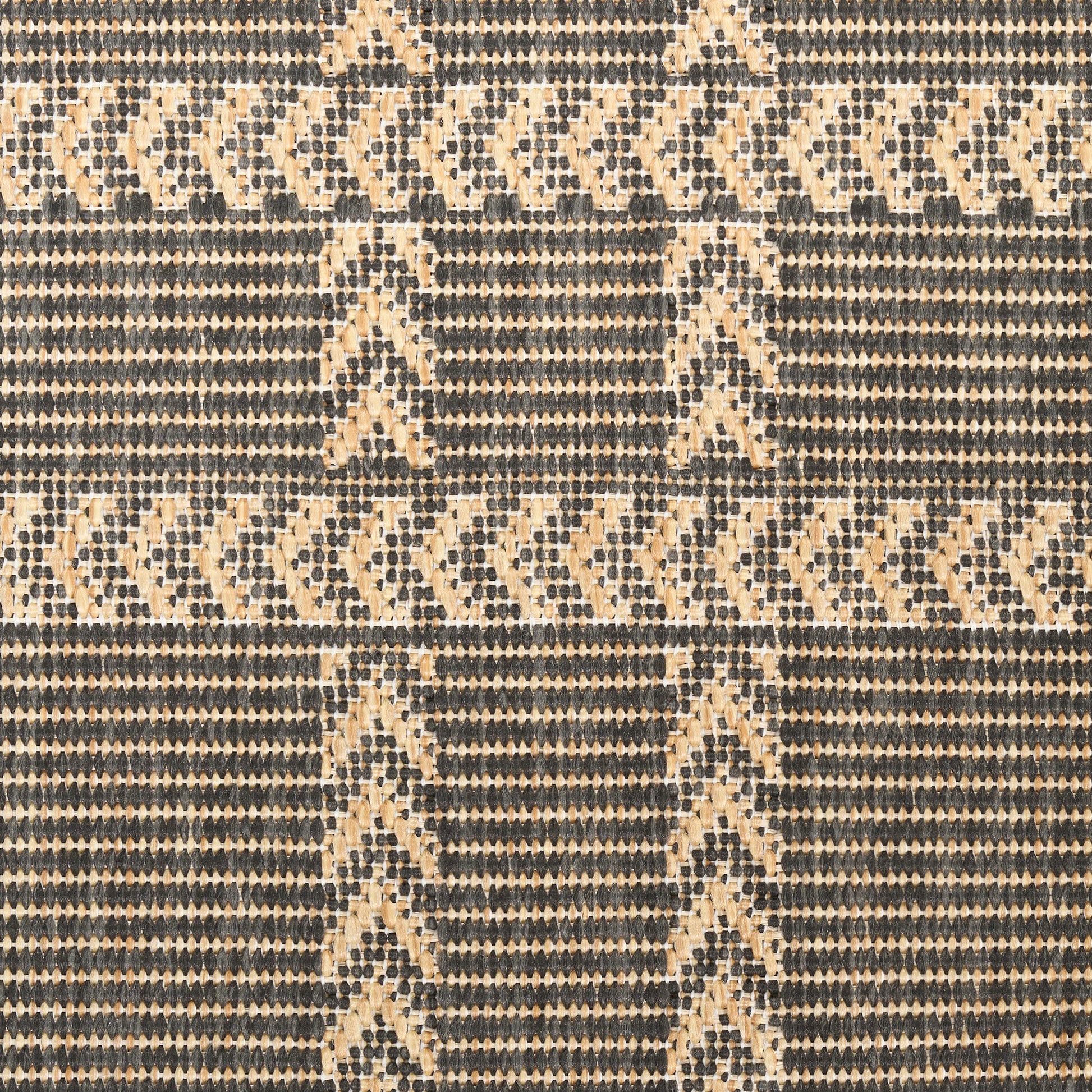 Beige and dark blue woven rug with chevron and diamond geometric pattern.