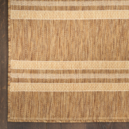 Natural fiber jute rug with beige and tan horizontal stripes, textured weave and fringe edges.