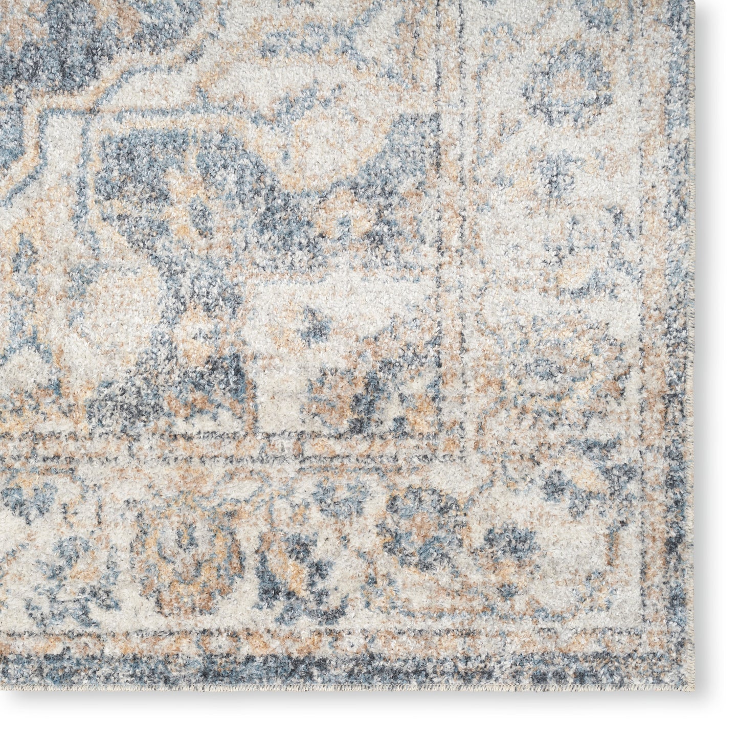 Rectangular beige and blue distressed oriental rug with floral motifs and soft pile.