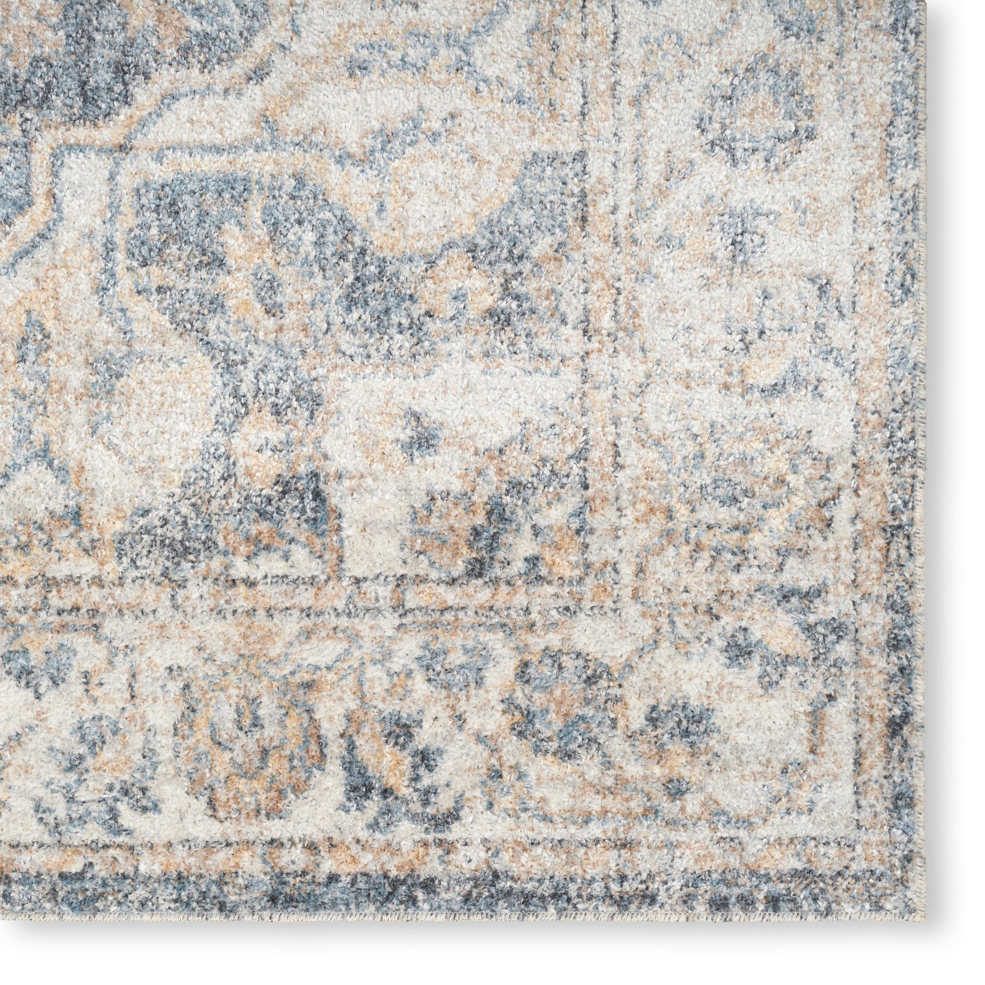 Rectangular beige and blue distressed oriental rug with floral motifs and soft pile.