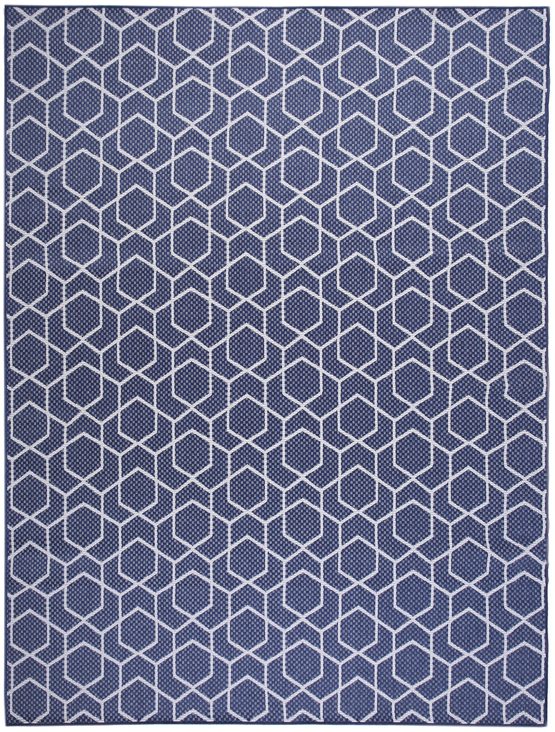 Navy blue rug with white hexagon lattice pattern; modern geometric flat-weave for contemporary living spaces.