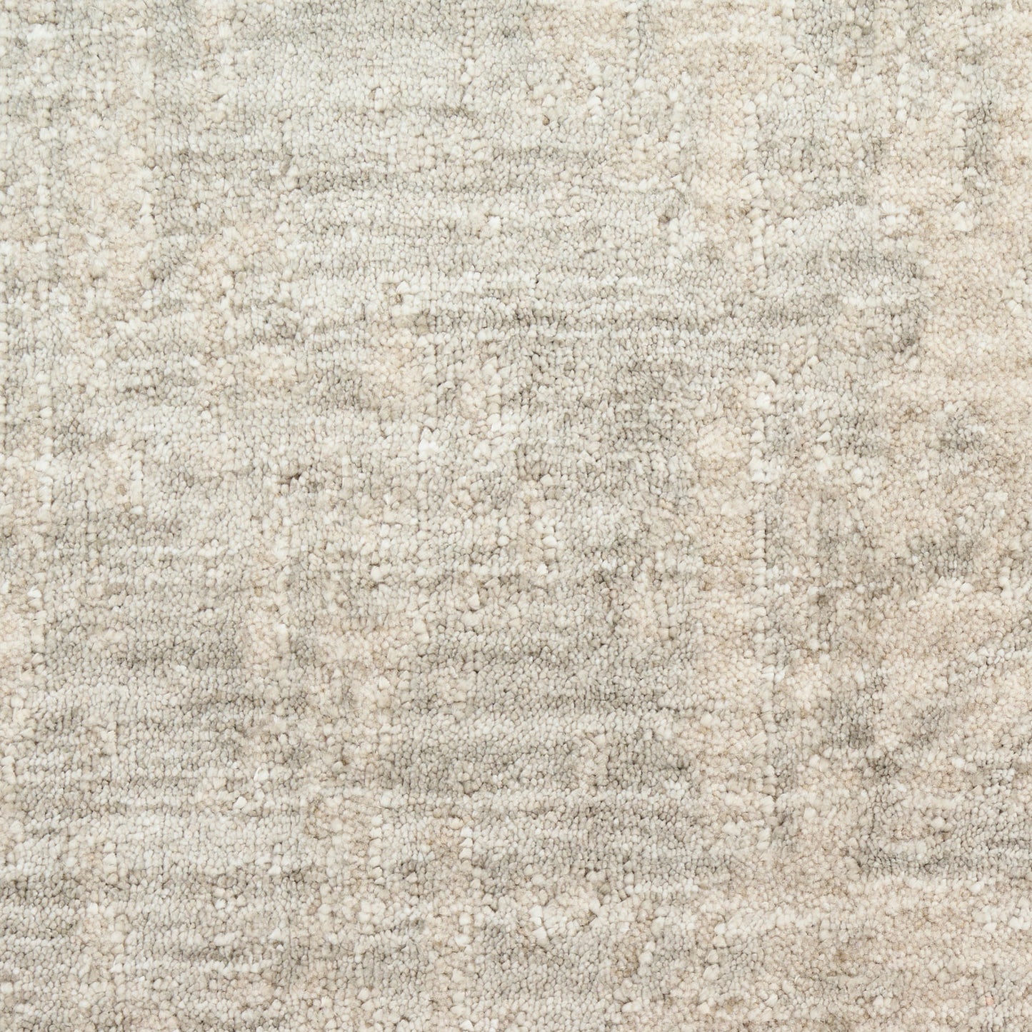 Cream-beige woven area rug with subtle mottled texture and soft, plush feel.