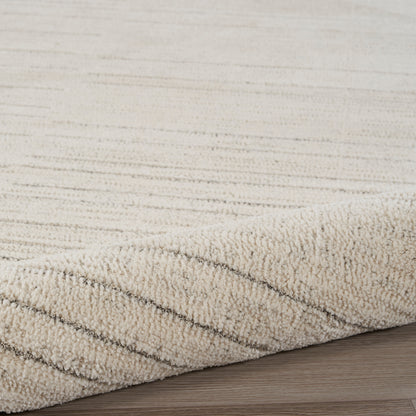 Beige textured area rug with diagonal stripe pattern and plush pile, rolled edge on light wood floor.