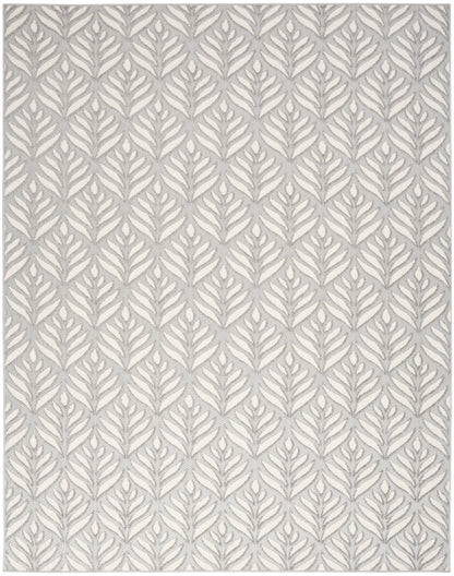 Rectangular rug with grey fern motif on ivory background; modern botanical woven pattern.