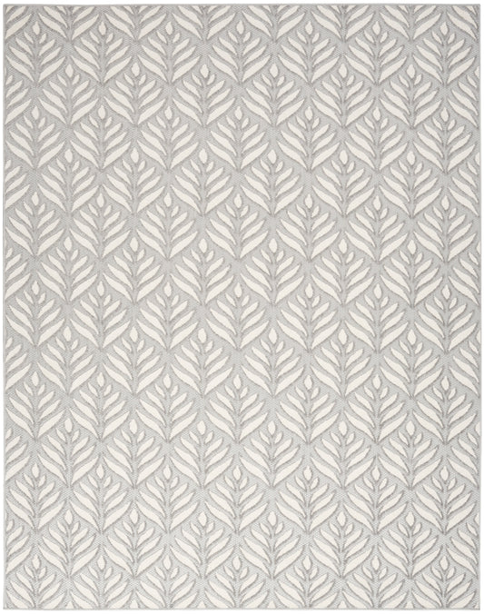 Rectangular rug with grey fern motif on ivory background; modern botanical woven pattern.