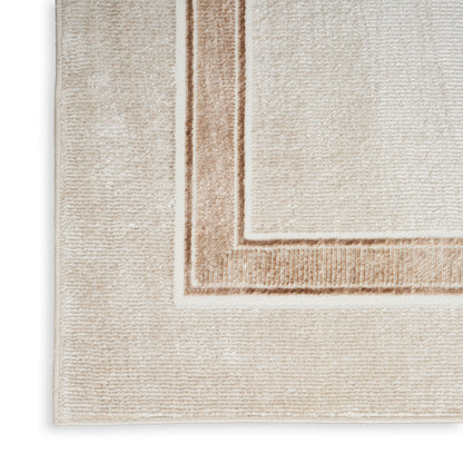 Beige area rug with cream center and layered tan border; soft textured woven surface.