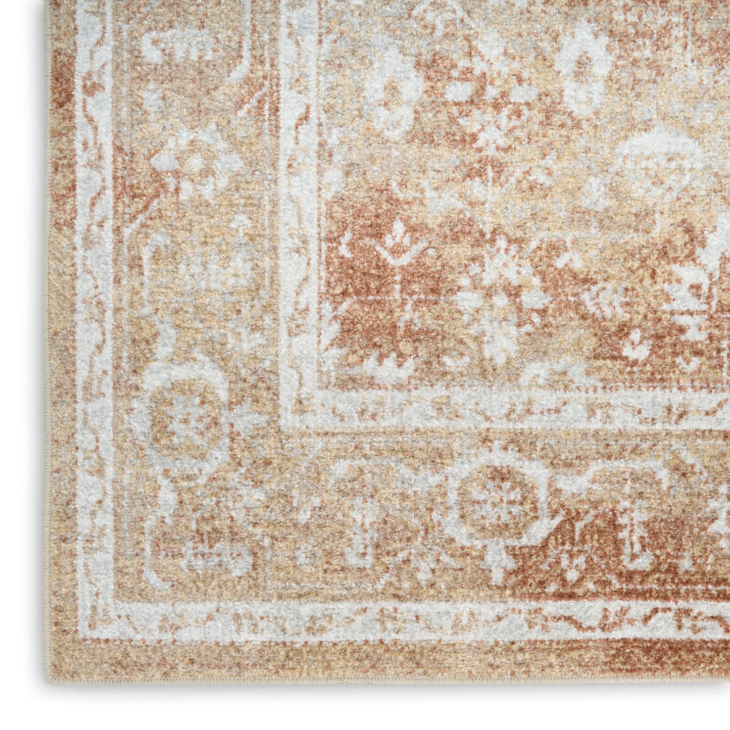 Beige vintage-style rug with ivory floral border and distressed warm-toned pattern.