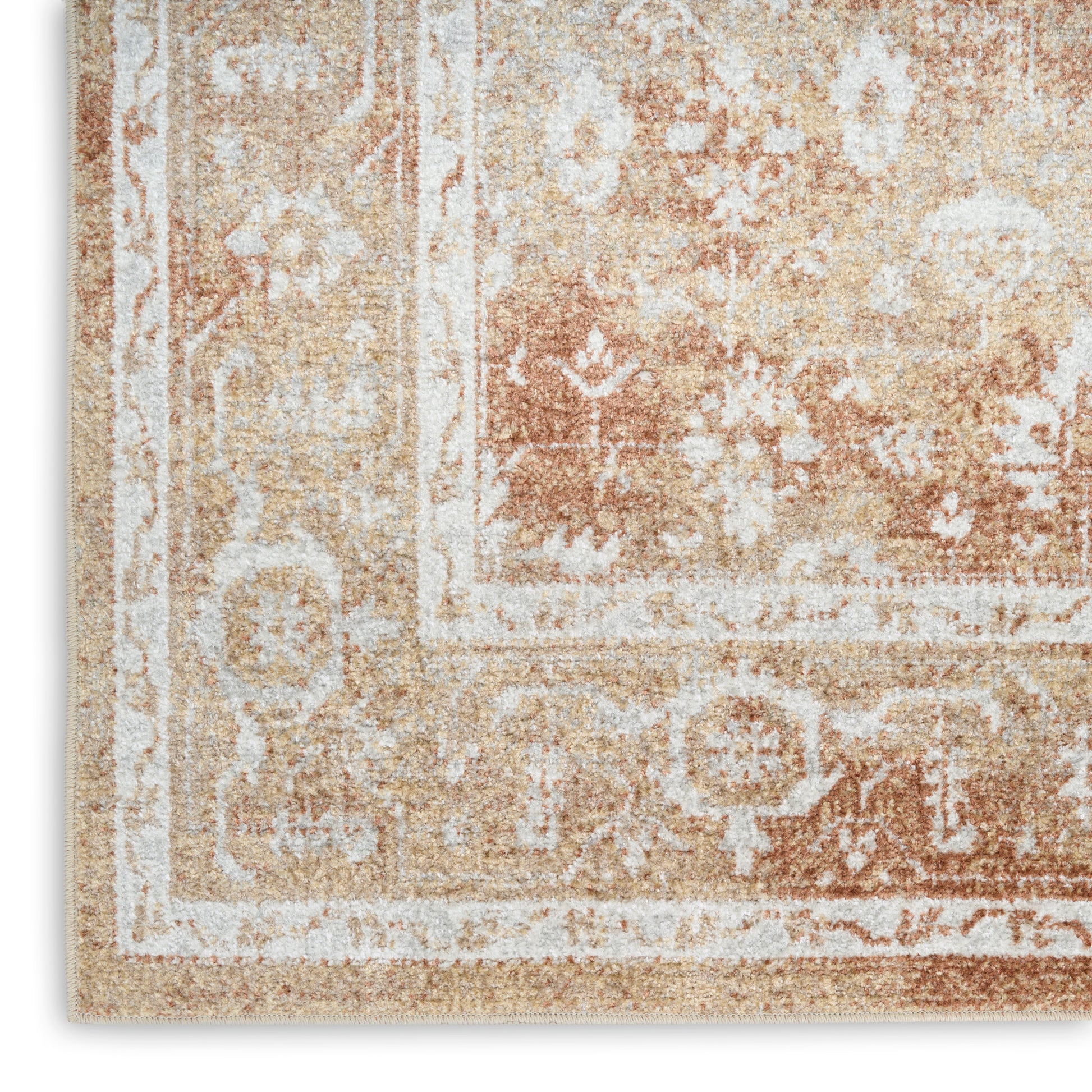 Beige vintage-style rug with ivory floral border and distressed warm-toned pattern.