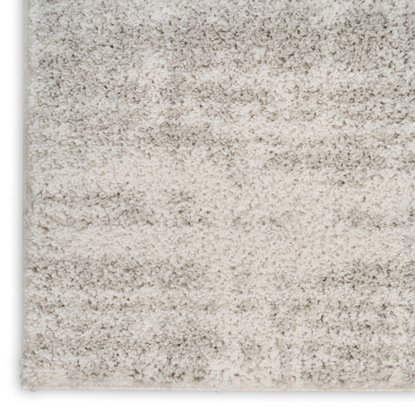 Neutral beige shag rug with gradient gray-tan tones and plush high-pile texture.
