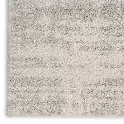 Neutral beige shag rug with gradient gray-tan tones and plush high-pile texture.