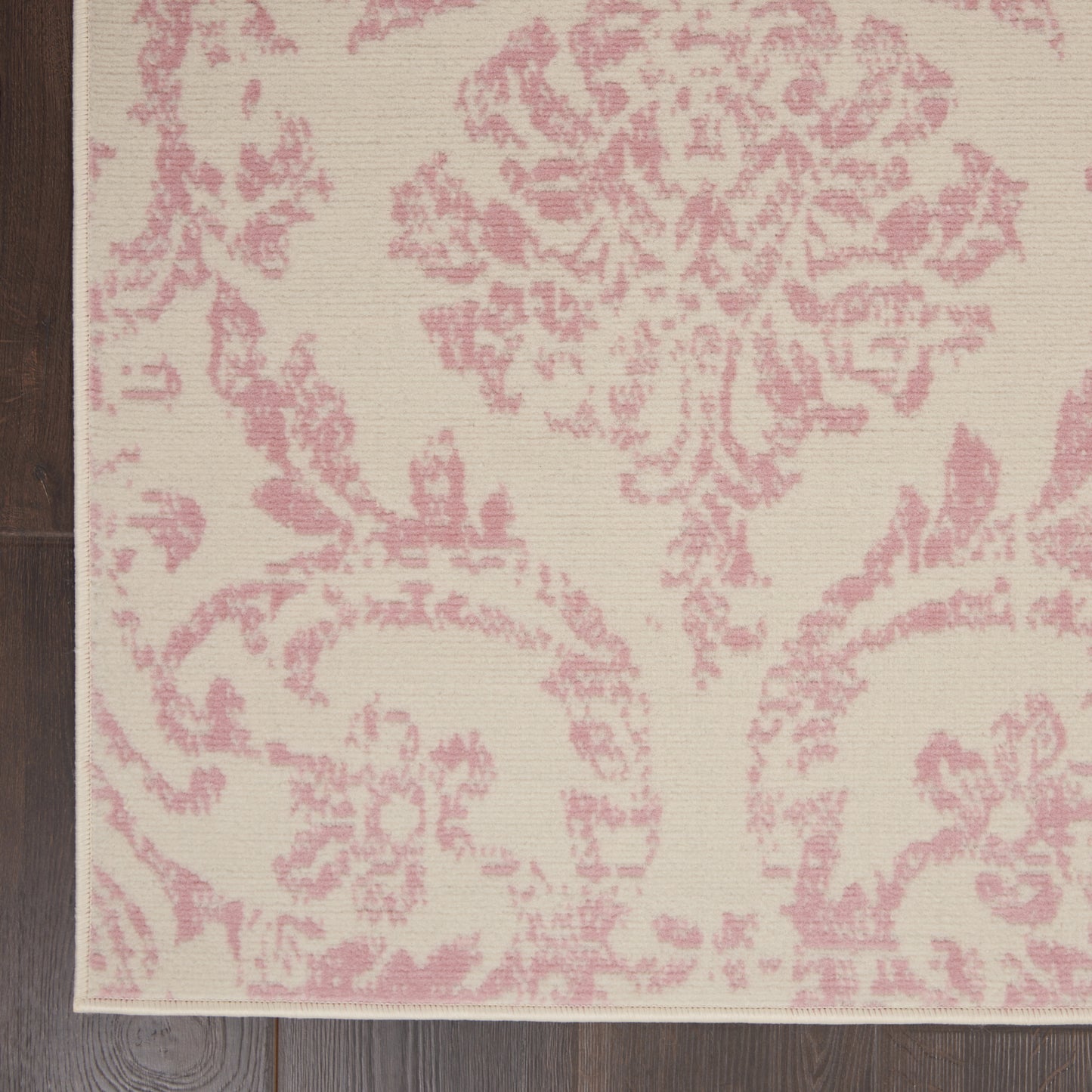 Beige rectangular rug with pink damask floral pattern; woven texture, decorative home decor accent.