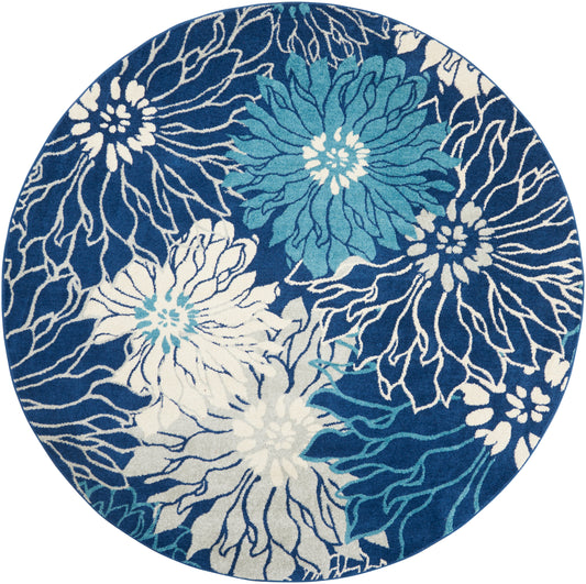 8' round rug with navy background and bold white and teal floral motifs, contemporary style.