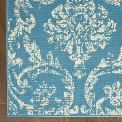 Blue rug with white damask floral pattern; vintage-style floor rug, 6' x 9'.