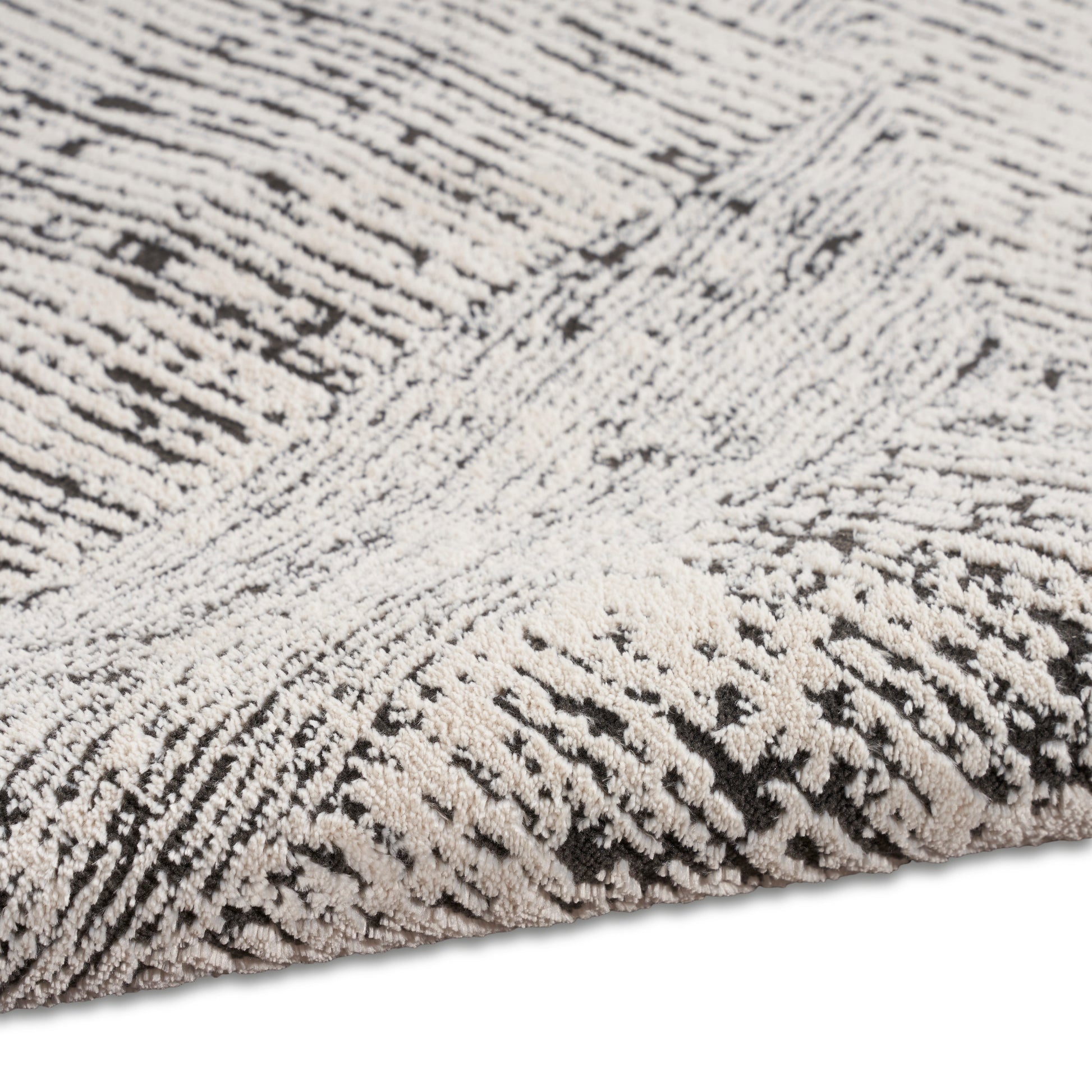 Gray and ivory plush shag rug with dense, tufted pile and subtle striped texture.