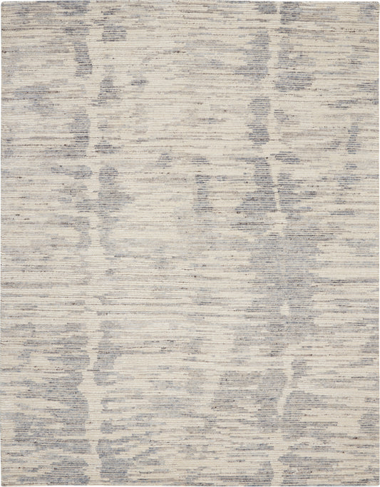 Rectangular area rug in cream & gray with abstract, distressed pattern for contemporary living spaces.