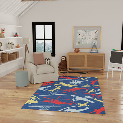 Rectangular blue kids' rug with multicolor airplane silhouettes in red, yellow, white and gray for a playful playroom.