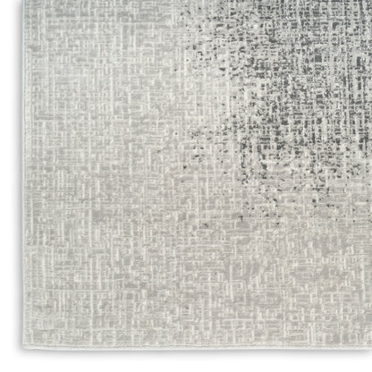 Rectangular light beige rug with subtle gray woven grid texture & soft, tactile surface, 5' x 7'.