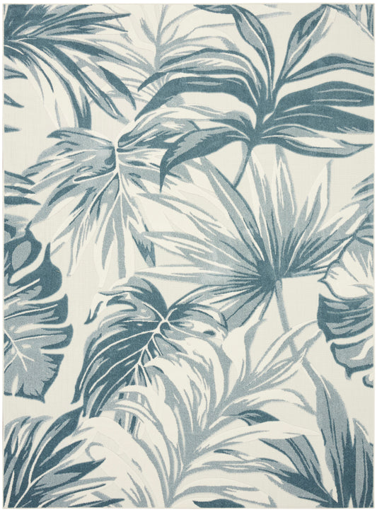 Blue-gray palm leaves tropical pattern on cream background; bold botanical rug decor.
