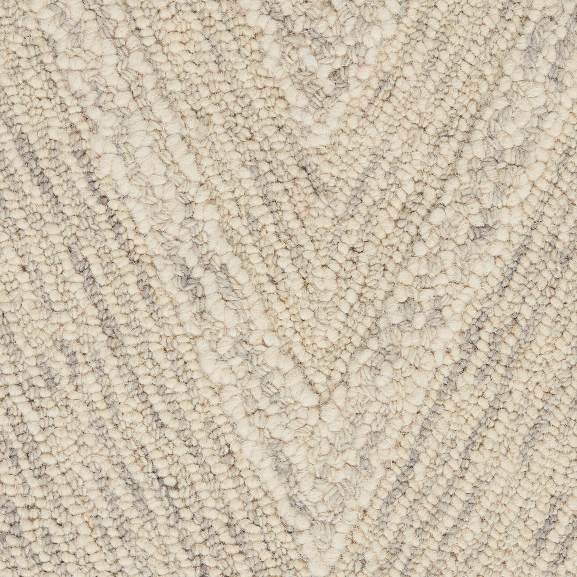 Cream shag rug with plush looped fibers and a soft gray chevron pattern.