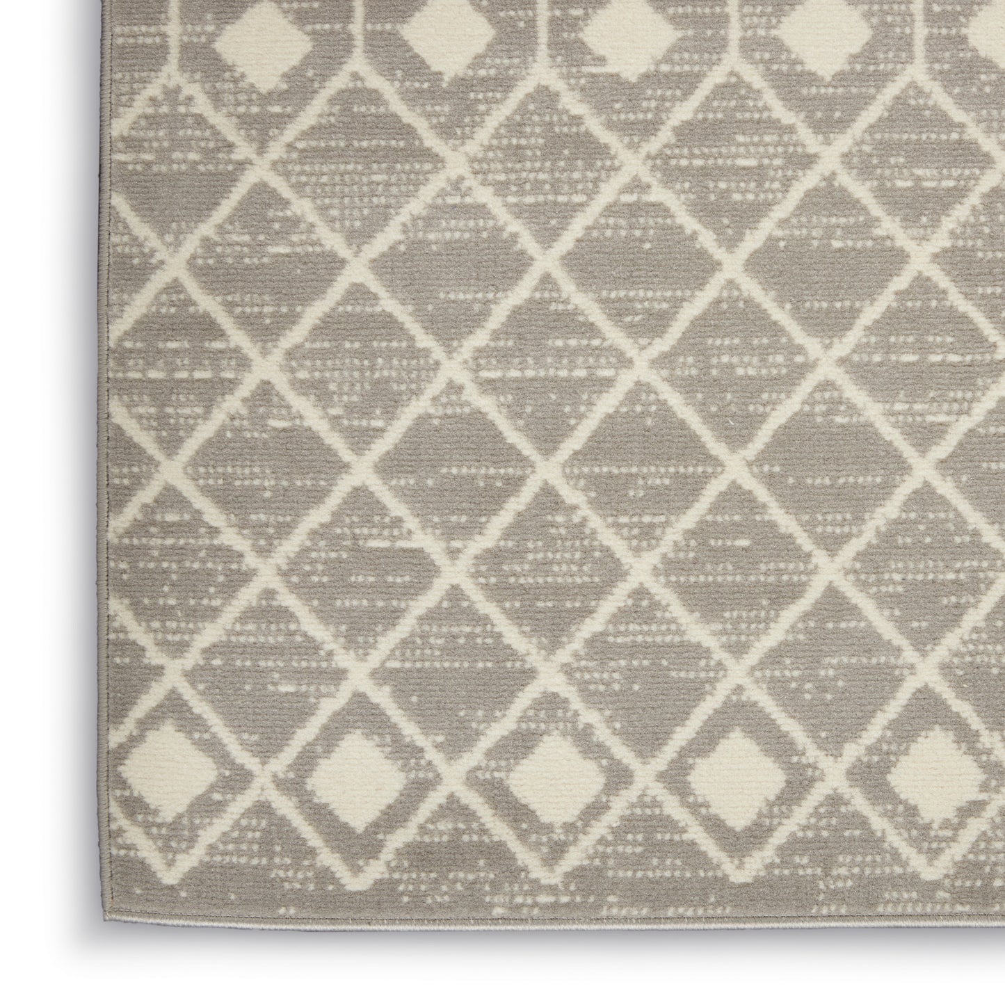 Neutral beige rug with white diamond lattice pattern and subtle textured flat-weave.