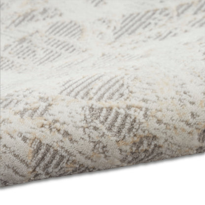 Cream & beige geometric shag rug with textured pile & diamond pattern.