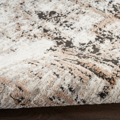 Plush shag area rug in cream, beige, taupe with abstract brown pattern; soft, textured pile.