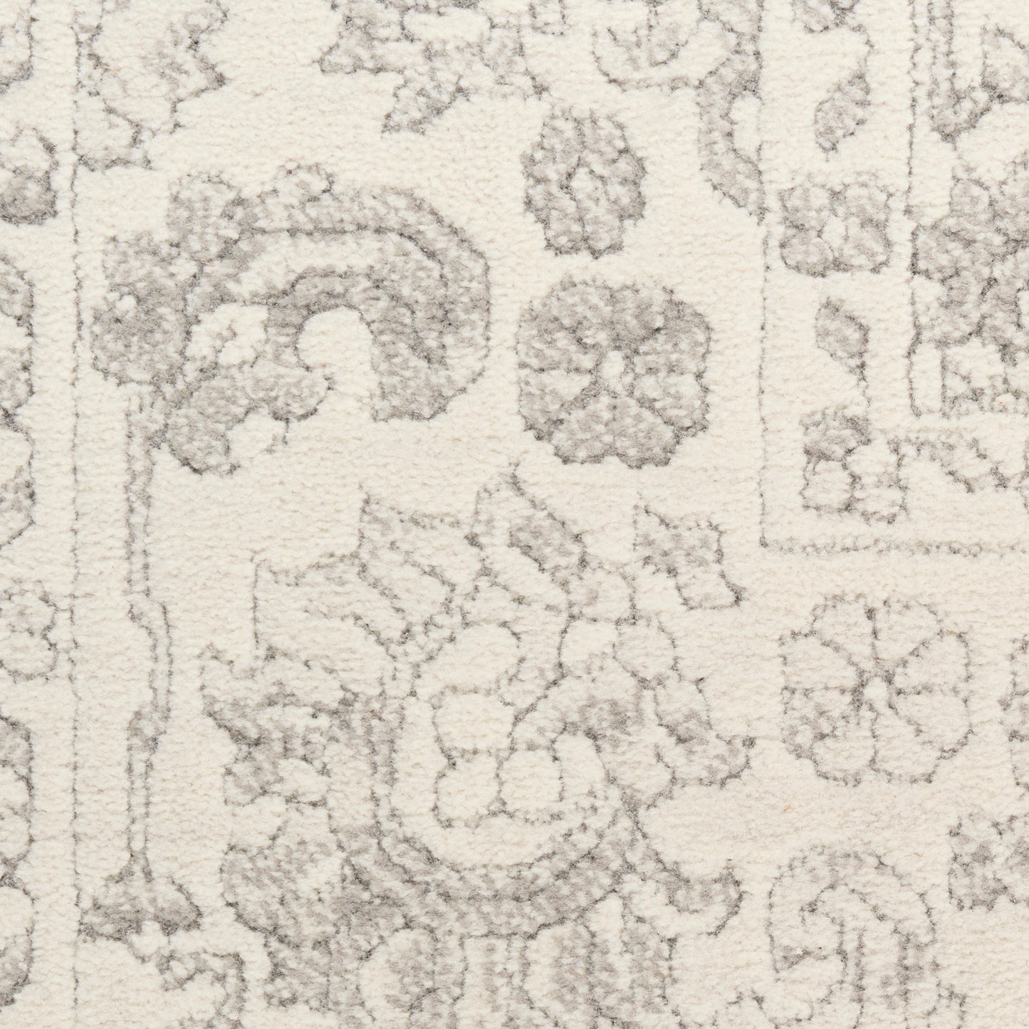Cream rug with light gray floral and medallion motifs in a Persian-style pattern.