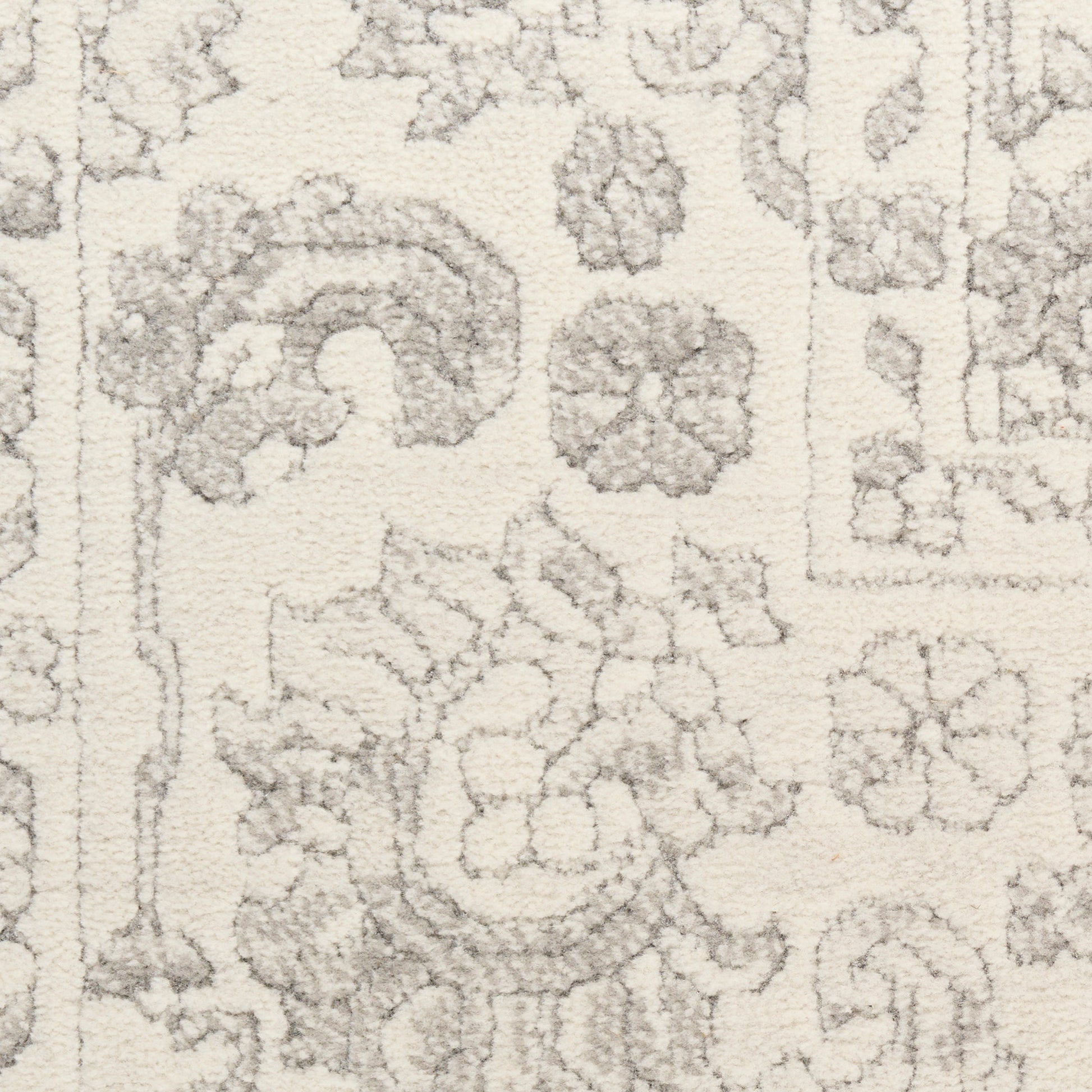 Cream rug with light gray floral and medallion motifs in a Persian-style pattern.