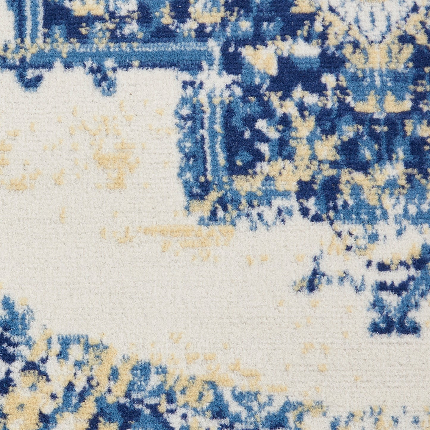Blue and beige abstract rug with a cream base and distressed pattern.