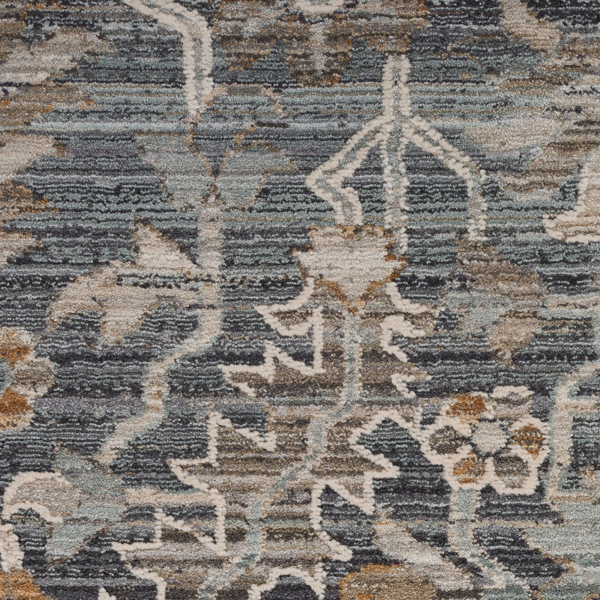 Blue-gray oriental rug with ivory floral motifs and warm beige-brown accents in a traditional, distressed design.
