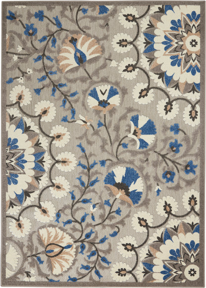 Rectangular area rug with beige background, blue and white floral medallions, brown vines, bordered edges.