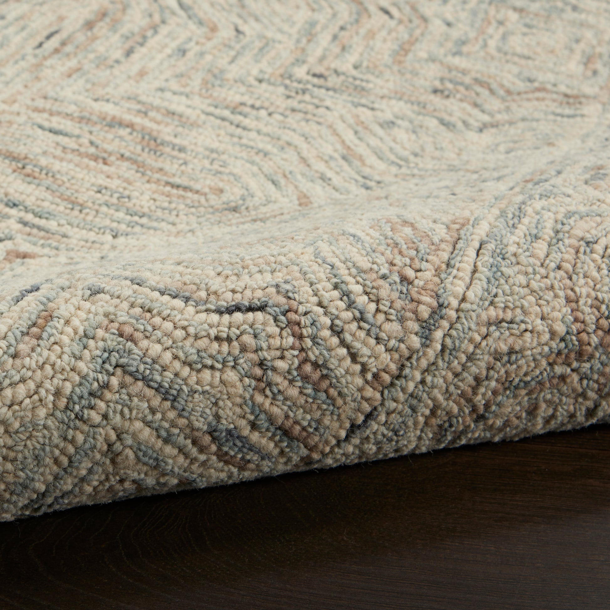 Neutral-toned plush rug with high-pile loop texture in beige, gray and blue-gray; geometric pattern, soft underfoot.
