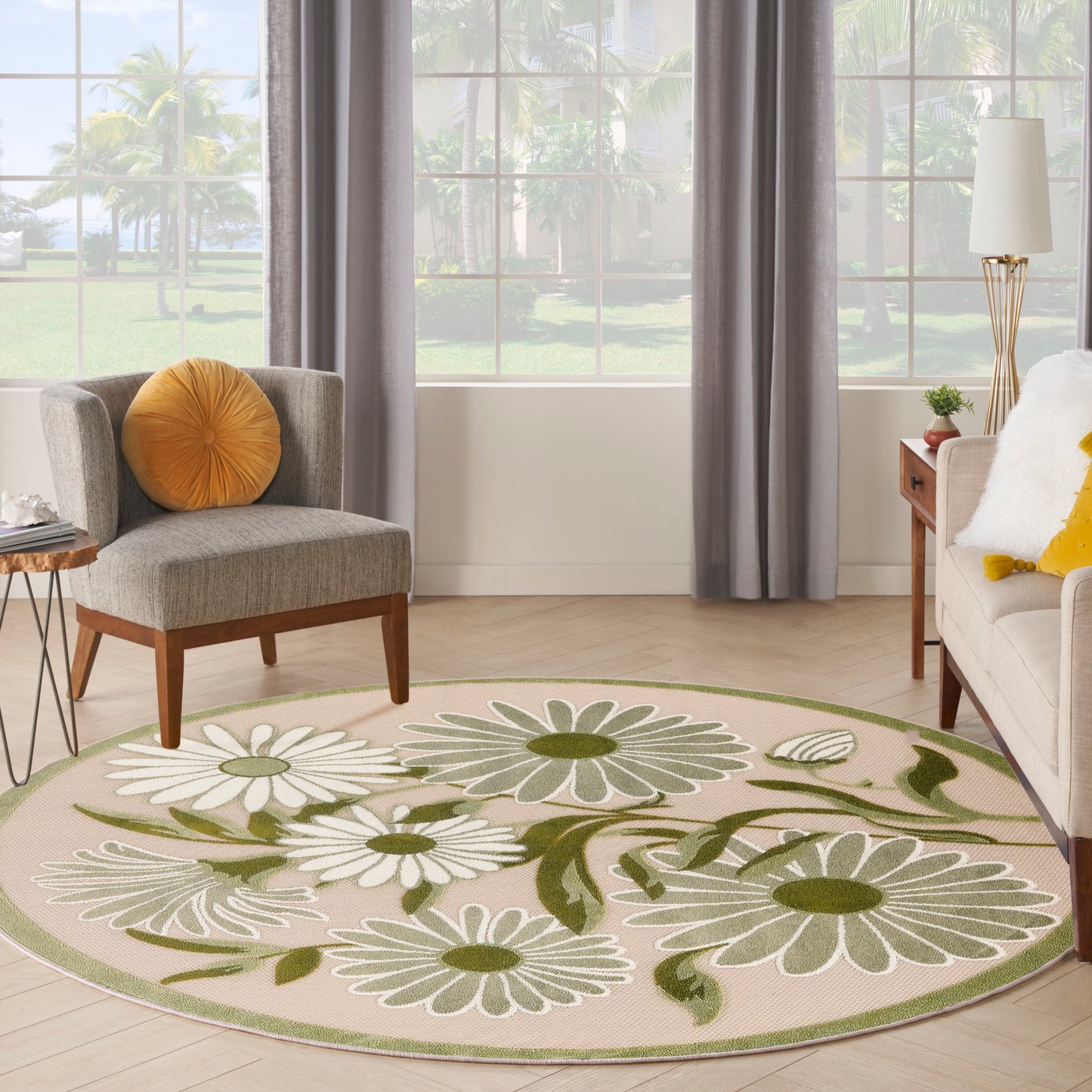 Round floral area rug with white daisies and green leaves on beige field, pale green border.