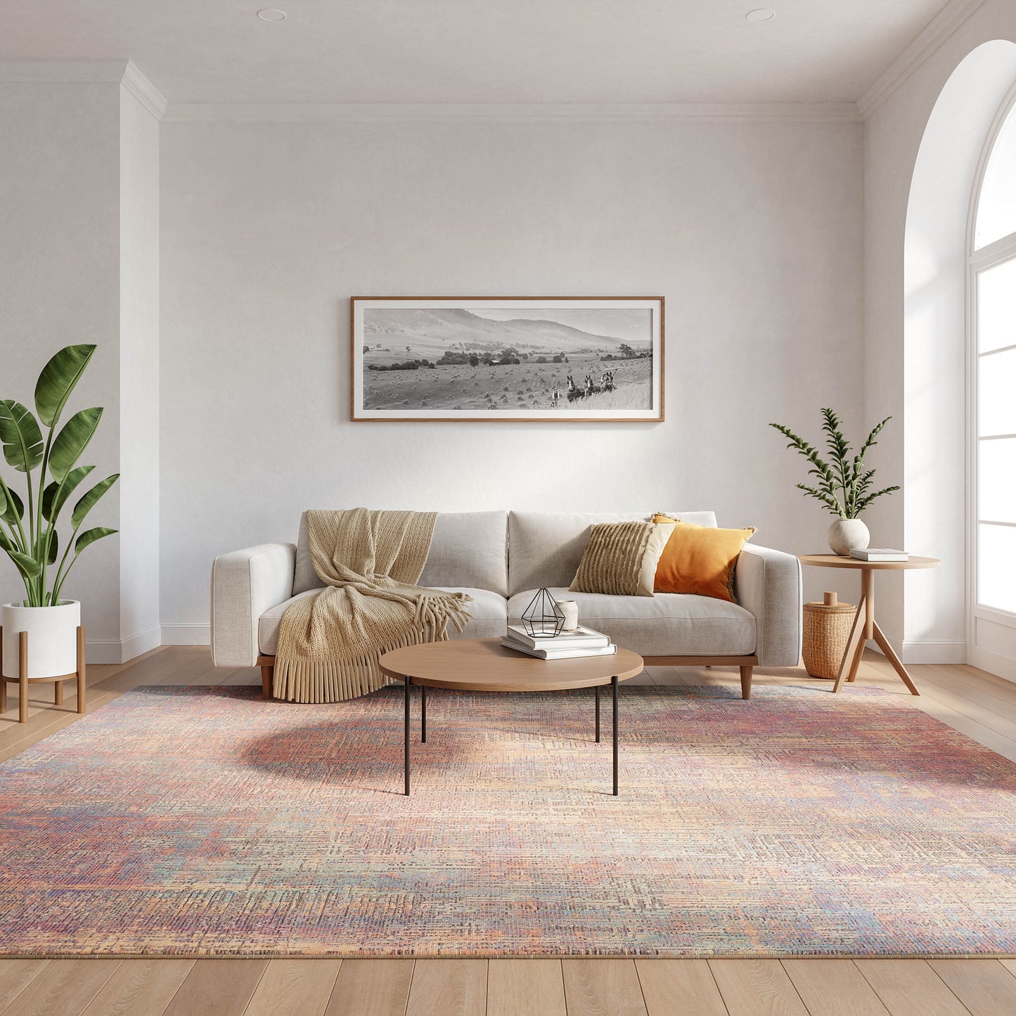 Cozy modern living room with beige sofa, cream throw, orange cushion, round wood coffee table, pastel rug, green plants.