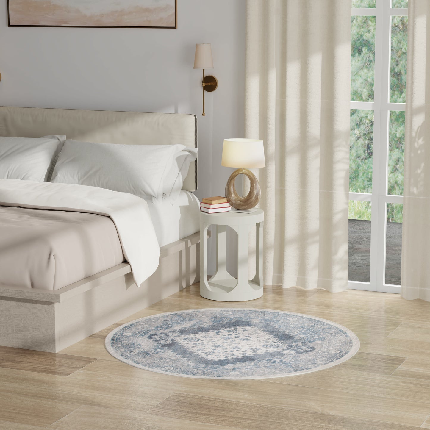 Neutral bedroom with cream bedding, round white side table, sculptural lamp, blue round rug, beige curtains, wooden floor.