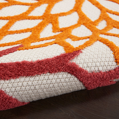 Close-up of a geometric patterned rug with orange lattice lines over cream background and maroon border, textured pile.