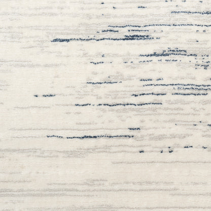 Cream area rug with subtle navy blue streaks, modern abstract style.