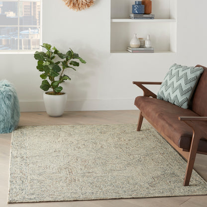 Mid-century brown leather sofa with a teal zigzag cushion, beige textured rug, potted plant, and white wall shelves.